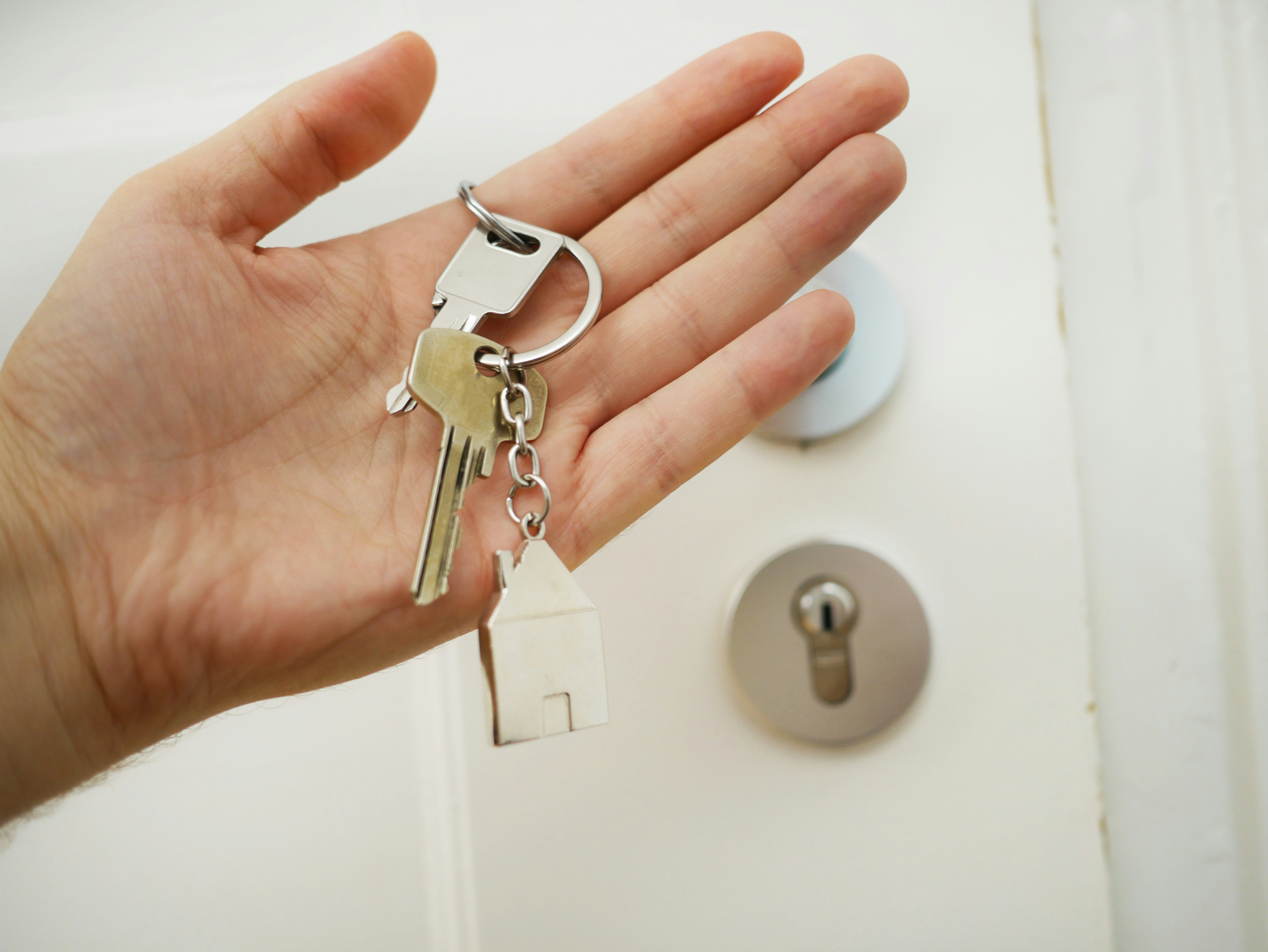 New homeowner holding the keys to their front door